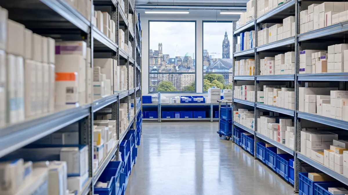 Tidy pharmaceutical warehouse aisle with sealed unbranded cartons and blue storage crates